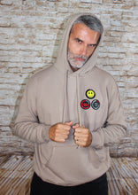 Load image into Gallery viewer, This new happy face hoodie offers a casual, relaxed fit for everyday wear. Oversized fit. Raw seams at shoulders and pocket. Oversized kangaroo pocked. 52% Airlume combed and ring-spun cotton, 48% poly fleece.  Edit alt text
